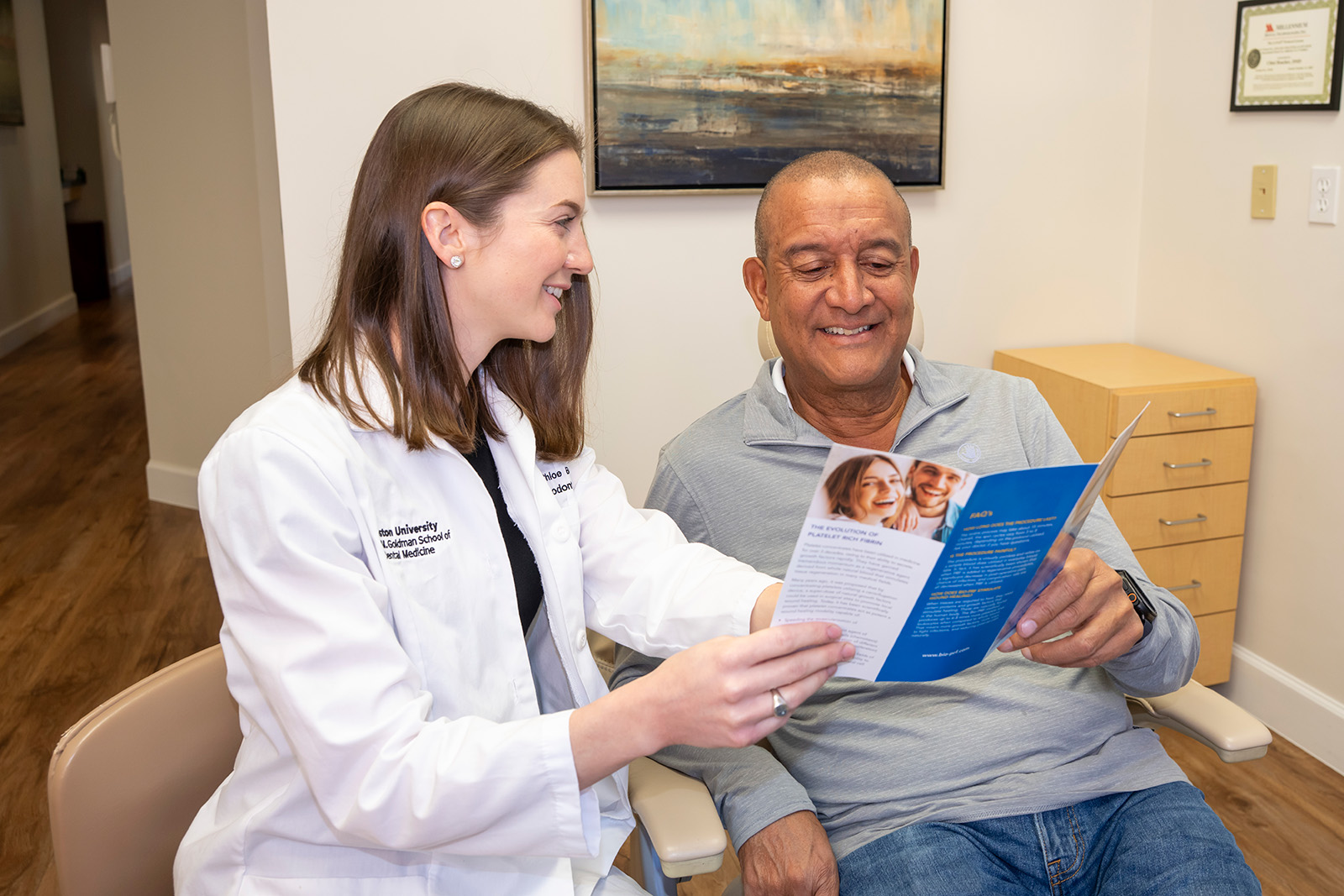 Dr. Boucher showing a patient a brochure