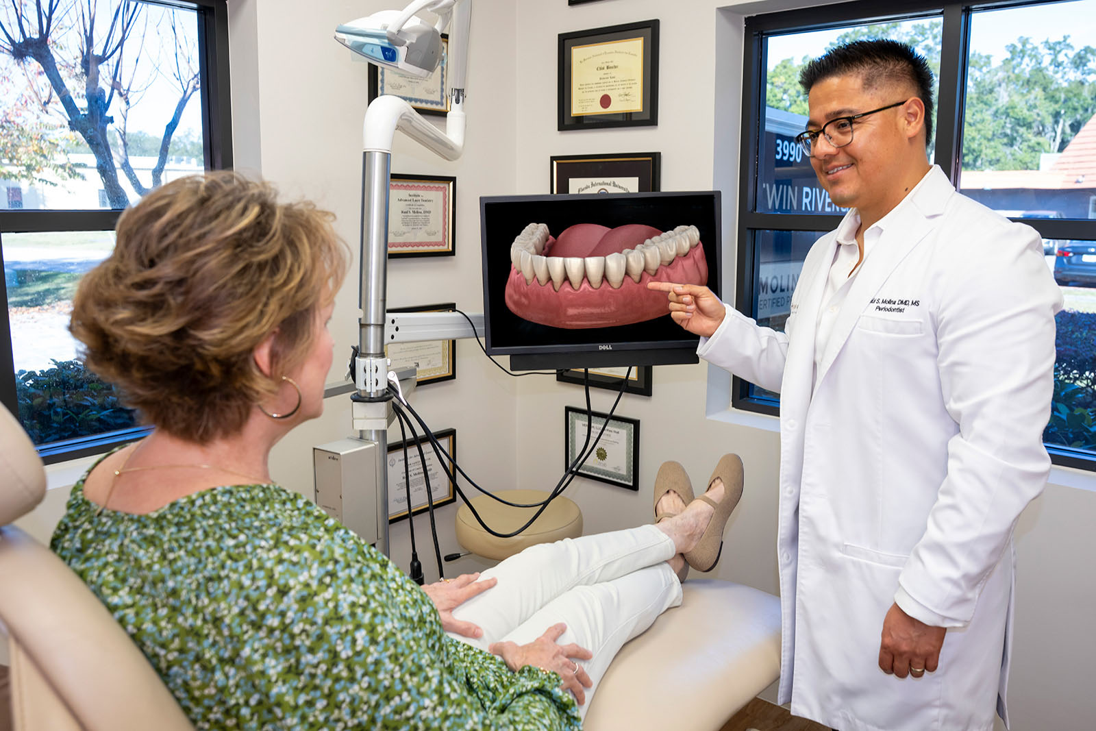 Dr. Molina showing a patient about recession gum treatment
